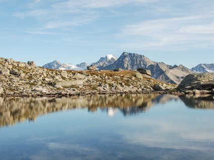 Hiking in Matrei am Brenner Mountain landscape with lake and rocks under a blue sky