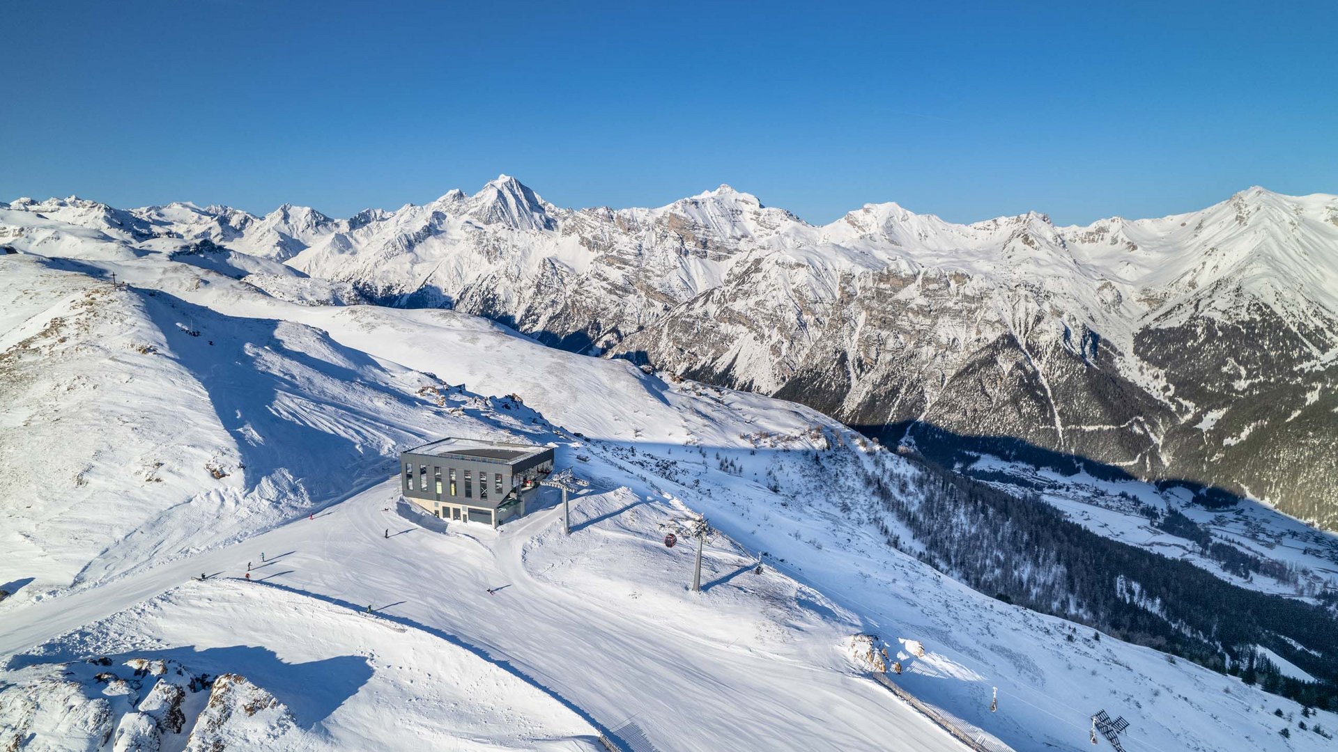 Discovering Wipptal Snow-covered mountains with ski lift station and clear blue sky