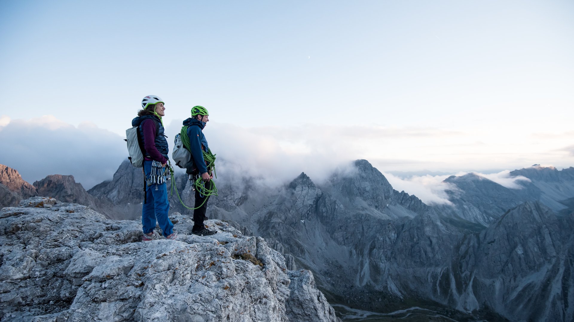 Holidays at the Brenner Pass: hiking and climbing Two climbers standing on a rock overlooking foggy mountain peaks