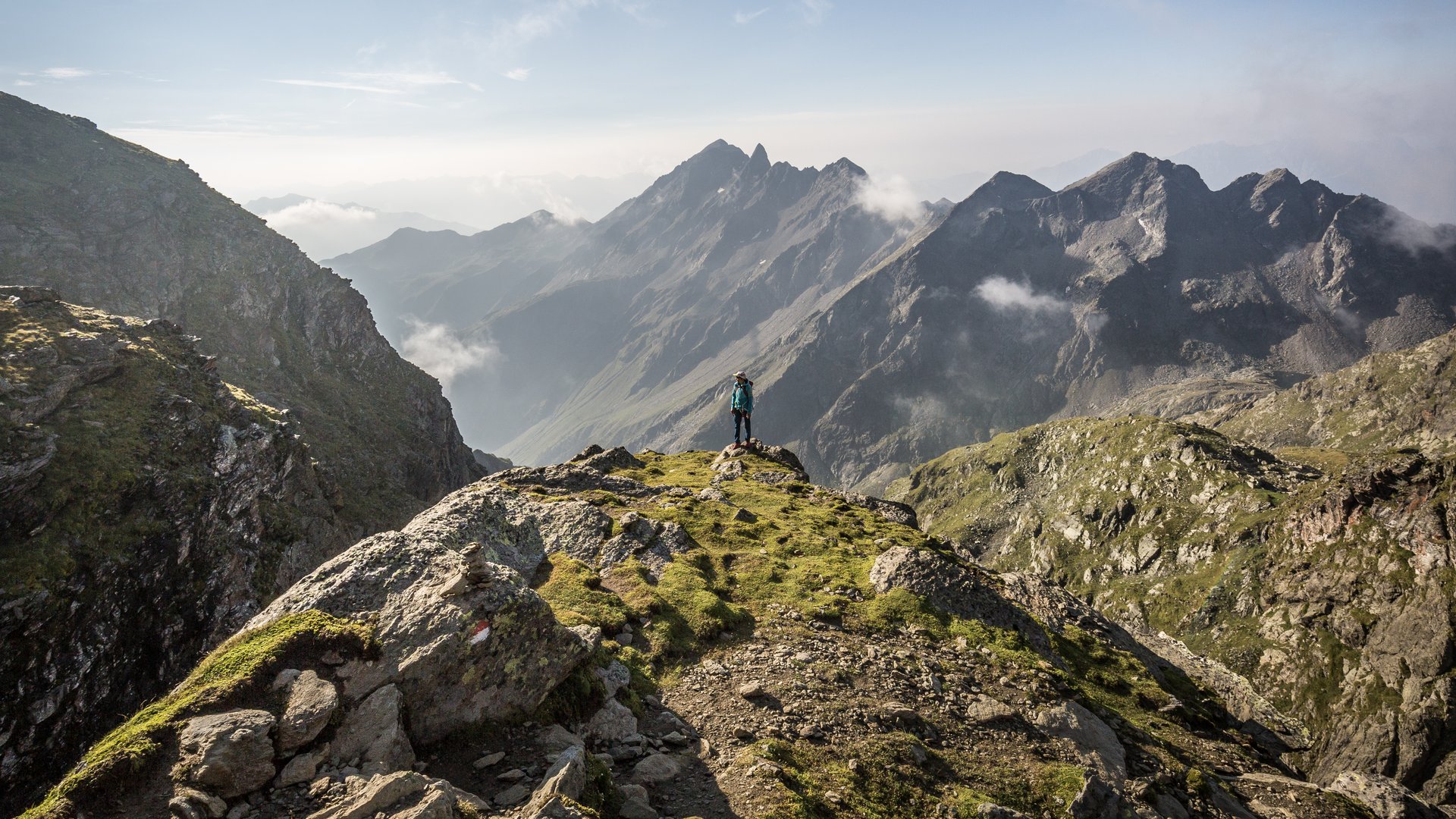 Visitare Innsbruck in un giorno o tutta la Wipptal Escursionista su vetta con vista su montagne nebbiose