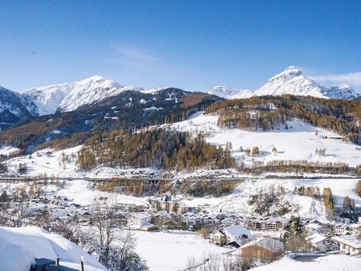 Your first choice for an overnight stay in Matrei am Brenner Snow-covered alpine landscape with village and mountains under blue sky